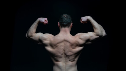 Fototapeta na wymiar bodybuilder man muscular back isolated on black. bodybuilder man muscular back