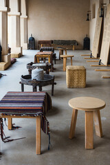 An old session of the ancient Qatari heritage. There are wicker chairs and wooden tables covered with colorful cloth, with metal tables with weaving threads .