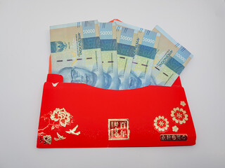 Chinese new year red money packet with the words best wishes for the new year with Indonesian fifty...