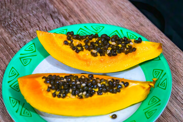 Fresh ripe papaya fruits on wooden table. sliced papaya 