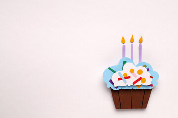 Birthday party. Paper cupcake with candles on white background, top view and space for text