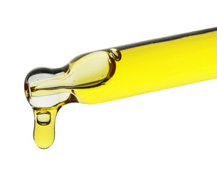 Dripping yellow facial serum from pipette on white background, closeup