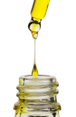 Dripping yellow facial serum from pipette into glass bottle on white background, closeup