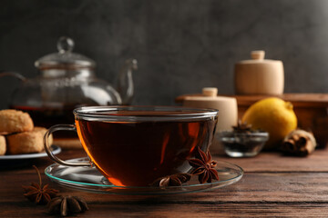 Obraz na płótnie Canvas Aromatic tea with anise stars on wooden table