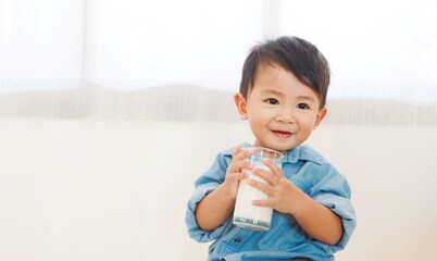 Boy drinking milk from glass And smiling happily, under the concept of drinking milk for good...