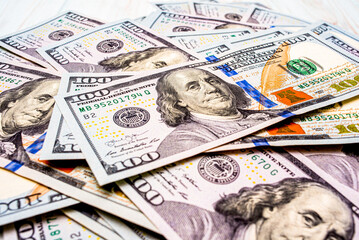 American currency on a white wooden background. Paper banknotes of one hundred dollars.