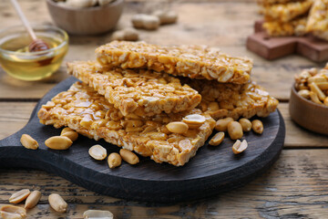 Delicious peanut kozinaki bars on wooden table, closeup
