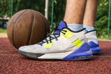 Basketball player with a ball on the court. Close up