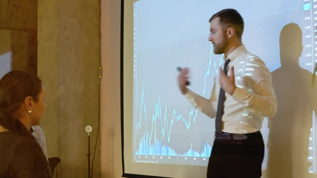 Business speaker is discussing with participants in the meeting of the prospect of growth or falling the cryptocurrency market