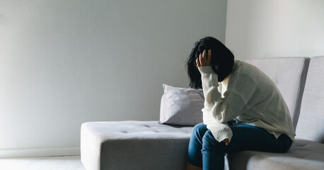 Concept of sad teenage girl depression. Upset teenage girl sitting at window indoors. Anxiety young...
