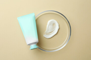 Petri dish and cosmetic product on beige background, top view