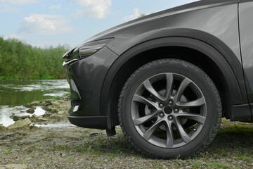 Fototapeta na wymiar New black modern car outdoors, closeup view