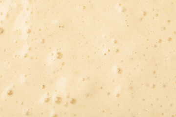 Tasty smoothie with bubbles as background, closeup