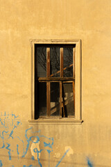 Minimalistic atmospheric photo. Staircase in window opening in yellow concrete wall of house. Concept of loneliness, depression, lifting up. Bright sunny day. Joy. Sun. Summer. Georgia. Tbilisi. Front
