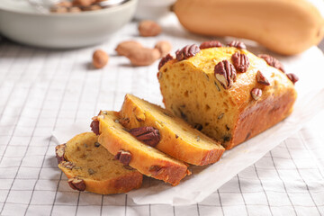 Delicious pumpkin bread with pecan nuts on tablecloth