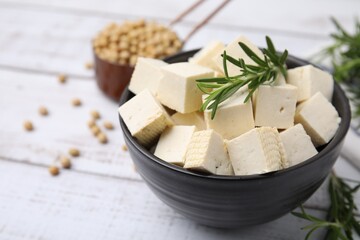Delicious tofu cheese, rosemary and soybeans on white wooden table, closeup