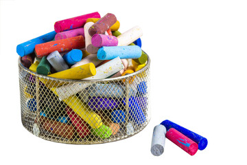 Cutout of an isolated set of colorful old and used oil pastels in an old basket for art with the transparent png
