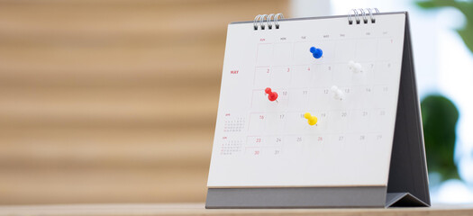 Closeup calendar page with drawing-pins , planning for business meeting or travel planning concept