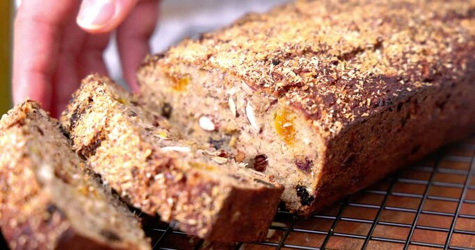 Woman baker and confectioner serve up freshly baked homemade sweet cake or healthy gluten free easter bread with fruits and nuts 4k video