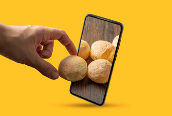 hand picking up cheese bread from inside smartphone screen, concept of online food ordering,...