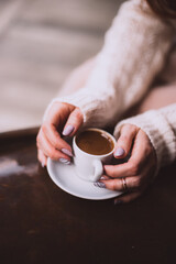Top view of woman hands with aromatic coffee