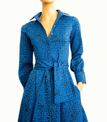 Bright blue dress on a mannequin. Women's clothing is elegant and modern. Modern style. Fashion bows