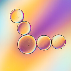 Creative lighting applied to macro photography frames these tiny little oil droplets in a colorful...