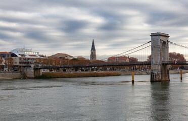 Fototapeta premium Bridge over the Rhone River in a small town, Tournon-sur-Rhone, France.