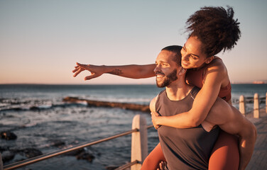 Fitness, couple and piggyback for beach sunset, travel or fun holiday journey together in the outdoors. Happy man and woman enjoying back ride by the ocean coast after running exercise or workout