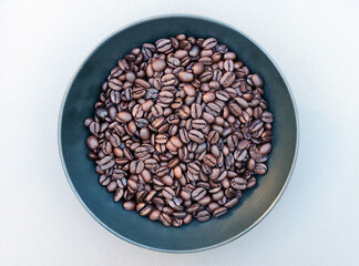 Espresso coffee beans in a black bowl