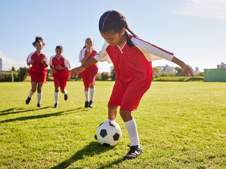 Soccer, training or sports and a girl team playing with a ball together on a field for practice....