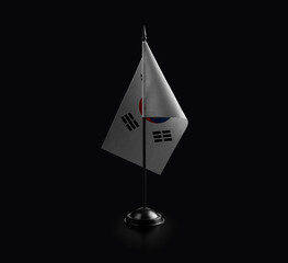 Small national flag of the South Korean on a black background