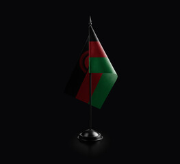 Small national flag of the Malawi on a black background