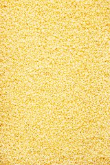 Couscous, dry wheat grain, food background texture, top view