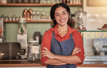 Portrait, cafe waiter and woman with arms crossed ready to take your order. Coffee shop, barista and confident, happy and proud young female employee from Brazil or small business owner of cafeteria. - obrazy, fototapety, plakaty