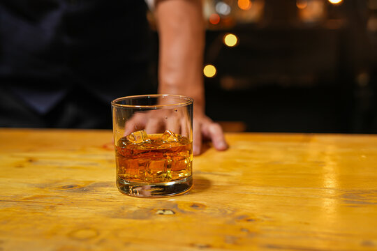 Bartender pouring Whiskey, on  bar - Powered by Adobe