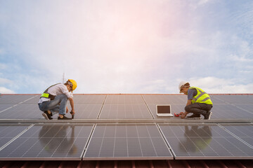 Engineering team working on checking and maintenance in solar power plant, Solar panel technician with drill installing solar panels on roof on a sunny day