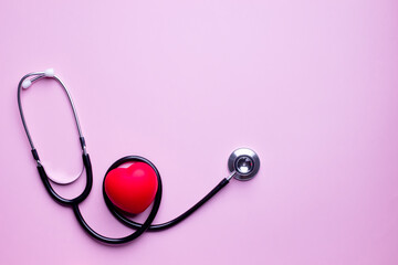 Flat lay of stethoscope is with red heartbeat for checkup. Heart attack prevention. A Health care concept.