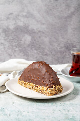 Chocolate Banana Cake. Malaga cake with banana inside, chocolate and hazelnut outside on a stone background. close up