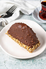Chocolate Banana Cake. Malaga cake with banana inside, chocolate and hazelnut outside on a stone background. close up