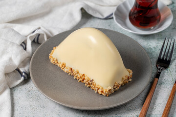 White Chocolate Banana Cake. Malaga cake with banana inside, chocolate and hazelnut outside on a stone background. close up