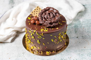 Chocolate and pistachio cake. Birthday or celebration cake on stone background. close up
