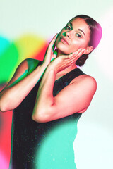 Woman, fashion and skincare portrait with neon light for a kaleidoscope party on a studio...