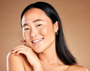 Portrait, beauty and treatment with a model asian woman in studio on a beige background for natural...