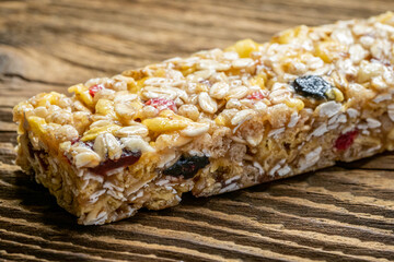 Cereal superfood energy bars with almond nuts, dry fruits, raisins chocolate on the wood table