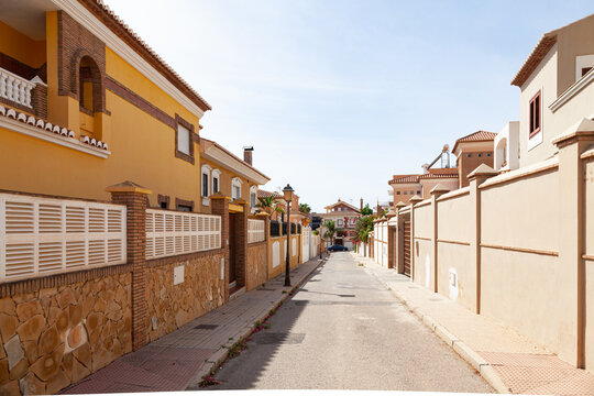 Fototapeta Spanish street in Motril city with private houses along the street.