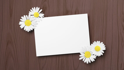 茶色い木目の背景に白い紙とお花。空白。手紙。（横長）