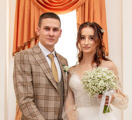 The bride and groom in a wedding dress.