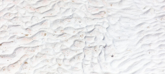 White volcanic limestone rock as background.