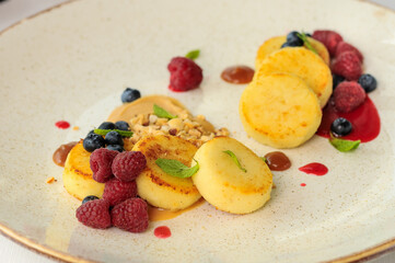 breakfast dessert sweet cheesecakes with berries in a plate macro
